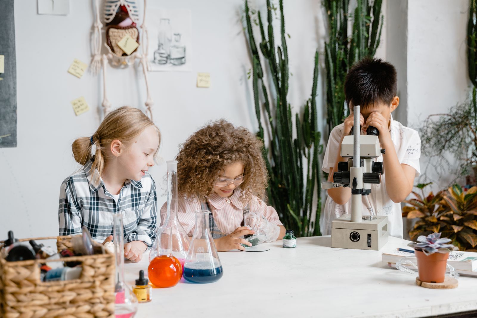 A group of children carrying out hands-on science experiments with lab equipment.